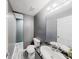 Bathroom features a toilet, vanity with marble countertop and sink, a large mirror, and neutral gray walls and flooring at 3068 River Oak Rd, Decatur, GA 30034