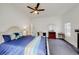 A bedroom featuring white walls, carpet flooring, a ceiling fan, and furniture including a bed and desk at 3068 River Oak Rd, Decatur, GA 30034
