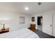 Bright bedroom with a bed, nightstand and a doorway leading to the kitchen at 3068 River Oak Rd, Decatur, GA 30034