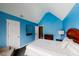 Bedroom features a vaulted ceiling, a modern mirror, and an accent chair at 3068 River Oak Rd, Decatur, GA 30034