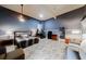 A bedroom with light hardwood floors, grey walls, a queen bed, a desk and chair set, and a cozy seating area at 3068 River Oak Rd, Decatur, GA 30034