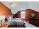 Cozy bedroom with red walls, a window, and a comfortable bed and warm decor at 3068 River Oak Rd, Decatur, GA 30034