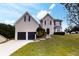 Charming two-story home boasts a well-manicured lawn and a two-car garage for ample parking at 3068 River Oak Rd, Decatur, GA 30034