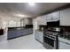 Well lit kitchen features stainless steel oven and range and a large granite topped counterspace at 3068 River Oak Rd, Decatur, GA 30034