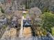 Full aerial view of the property and surrounding neighborhood, trees, and driveway at 3125 Peachtree Ne Dr, Atlanta, GA 30305