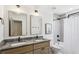 Bathroom with double vanity, granite countertop, tub, shower, and tile flooring at 3125 Peachtree Ne Dr, Atlanta, GA 30305