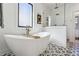 Beautiful bathroom with a freestanding tub, shower with herringbone tile, and patterned tile flooring at 3125 Peachtree Ne Dr, Atlanta, GA 30305