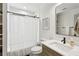 Neutral bathroom with subway tile, a black framed shower and a wood-look vanity at 3125 Peachtree Ne Dr, Atlanta, GA 30305