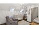 Well-lit Bedroom with skylights, a crib, a comfortable armchair, and stylish decor at 3125 Peachtree Ne Dr, Atlanta, GA 30305