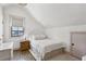 Cozy bedroom featuring a sloped ceiling, neutral decor, and a window with natural light at 3125 Peachtree Ne Dr, Atlanta, GA 30305