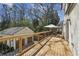 Spacious wooden deck overlooking a lush backyard with a detached garage at 3125 Peachtree Ne Dr, Atlanta, GA 30305