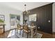 Elegant dining area featuring wainscoting, modern lighting, and a walkout to the deck at 3125 Peachtree Ne Dr, Atlanta, GA 30305