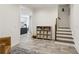 Bright entryway with gray tile flooring, open access to a living area and staircase at 3125 Peachtree Ne Dr, Atlanta, GA 30305