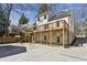 View of house with wood deck and stone accents, leading to concrete patio at 3125 Peachtree Ne Dr, Atlanta, GA 30305