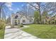 Classic home features a beautiful lawn and is complemented by mature trees and landscaping at 3125 Peachtree Ne Dr, Atlanta, GA 30305