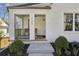 The front porch offers a cozy seating area and inviting entrance with blue painted ceiling at 3125 Peachtree Ne Dr, Atlanta, GA 30305