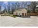 Detached three-car garage with painted brick and a large parking area at 3125 Peachtree Ne Dr, Atlanta, GA 30305
