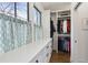 Bright walk-in closet with custom cabinets, quartz countertop, and two windows at 3125 Peachtree Ne Dr, Atlanta, GA 30305
