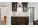 Basement wet bar with glass front cabinets, stylish hardware, and a mosaic backsplash at 3125 Peachtree Ne Dr, Atlanta, GA 30305