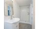 Bright bathroom features a vanity with modern faucet and walk-in shower with white subway tile at 1007 S Candler St, Decatur, GA 30030