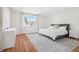 Bright bedroom with hardwood floors, natural light and simple decor at 1007 S Candler St, Decatur, GA 30030