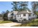 Charming home exterior with a well-manicured lawn, driveway, and fenced yard at 1007 S Candler St, Decatur, GA 30030