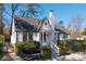 Charming white home featuring a manicured lawn, complemented by beautiful bushes at 1007 S Candler St, Decatur, GA 30030