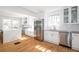 Spacious kitchen featuring modern stainless steel appliances, white cabinets, and hardwood floors at 1007 S Candler St, Decatur, GA 30030