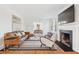 Inviting living room with a fireplace, leather couch and hardwood floors at 1007 S Candler St, Decatur, GA 30030