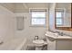 Cozy bathroom featuring a tub, toilet and sink with decorative mirror and natural light at 1269 Lawndale Ct, Decatur, GA 30032