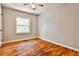 Bedroom featuring hardwood floors, a ceiling fan, and a window offering natural light at 1269 Lawndale Ct, Decatur, GA 30032