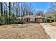 Charming red brick home featuring a well-maintained front yard and a convenient carport at 1269 Lawndale Ct, Decatur, GA 30032