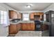 Well-lit kitchen features tile floors, wooden cabinets, and granite countertops at 1269 Lawndale Ct, Decatur, GA 30032