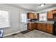 Well-lit kitchen features tile floors, wooden cabinets, and granite countertops at 1269 Lawndale Ct, Decatur, GA 30032