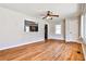 Bright living room featuring hardwood floors, a ceiling fan, and a view into the kitchen at 1269 Lawndale Ct, Decatur, GA 30032