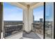 Balcony with iron railing offering city and wooded views on a bright sunny day at 2828 Peachtree Nw Rd # 1701, Atlanta, GA 30305