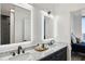 Bathroom showcasing double sinks, LED mirrors, marble countertop, and view to bedroom at 2828 Peachtree Nw Rd # 1701, Atlanta, GA 30305