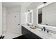 Bathroom featuring a double vanity with marble countertop, LED mirrors, and modern matte black fixtures at 2828 Peachtree Nw Rd # 1701, Atlanta, GA 30305