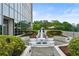 Beautiful outdoor area featuring a fountain with colorful flowers, green foliage, and a view of the building at 2828 Peachtree Nw Rd # 1701, Atlanta, GA 30305