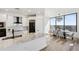 Open kitchen and dining area with large windows offering scenic views at 2828 Peachtree Nw Rd # 1701, Atlanta, GA 30305