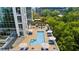 Aerial shot of a stunning pool deck with lounge chairs, umbrellas, and green trees around the edge at 2828 Peachtree Nw Rd # 1701, Atlanta, GA 30305