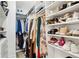 Spacious walk-in closet with shelving, rods for hanging clothes, shoes, and accessories at 2828 Peachtree Nw Rd # 1701, Atlanta, GA 30305