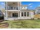 Beautiful backyard view of the home with a covered patio and lush green lawn at 52 25Th Nw St, Atlanta, GA 30309