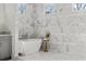 Bright and stylish bathroom featuring a modern bathtub and marble tile with natural light from three windows at 52 25Th Nw St, Atlanta, GA 30309