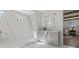 Beautiful primary bathroom with marble tiling, walk-in shower, gray cabinets and view to the bedroom at 52 25Th Nw St, Atlanta, GA 30309