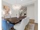 Dining room with modern light fixture, hardwood floors, and a large table with seating for eight at 52 25Th Nw St, Atlanta, GA 30309