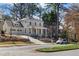 Elegant two-story white home with a covered front porch and an attached garage at 52 25Th Nw St, Atlanta, GA 30309