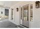 Close-up of the gray front door, flanked by sidelights and sconce lighting at 52 25Th Nw St, Atlanta, GA 30309