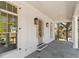 Covered front porch features stone flooring and white columns at 52 25Th Nw St, Atlanta, GA 30309