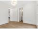 Hallway featuring hardwood floors and access to a powder room with modern lighting at 52 25Th Nw St, Atlanta, GA 30309